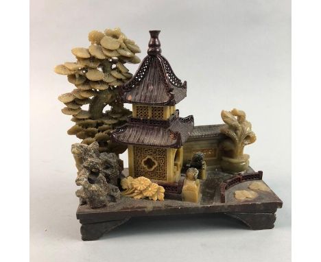SOAPSTONE CARVING, of a pagoda with trees, on a rectangular base, raised on four bracket feet, 18.5cm high