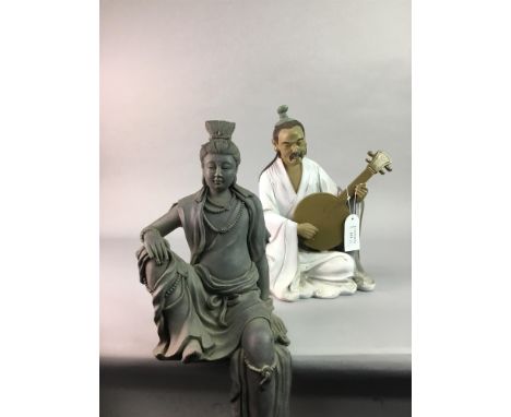 A CHINESE GLAZED CERAMIC FIGURE, modelled cross legged playing an instrument; along with another Chinese glazed ceramic figur