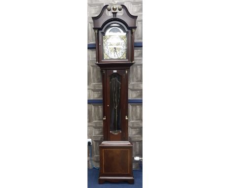 A REPRODUCTION LONGCASE CLOCK, with arched brass dial, in a mahogany case