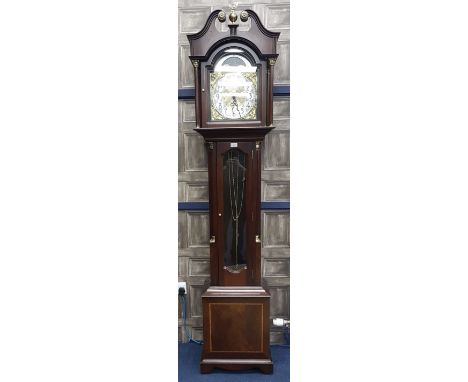 A REPRODUCTION LONGCASE CLOCK, with arched brass dial, in a mahogany case