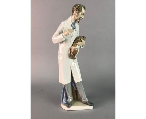 FOUR LLADRO FIGURES, including a figure of a vet; along with a Leonardo Collection figure group