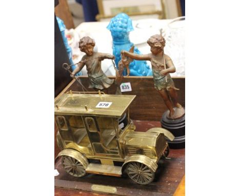 Pair of Spelter Figures of Cherubs together with a Gilt Metal Vintage Style Taxi on Wooden Stand