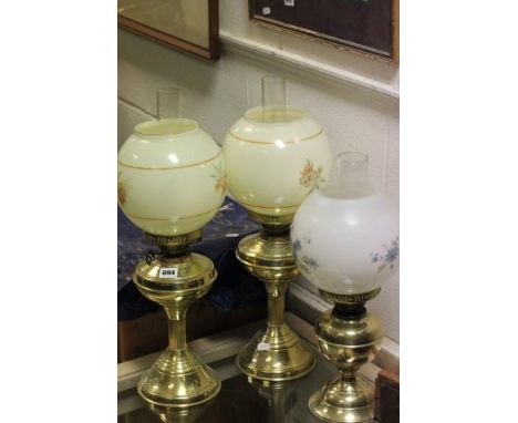 Matching Pair of Brass Oil Lamps and another Oil Lamp, all with glass globe Shades