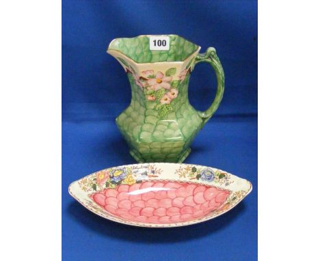Two Maling ware items comprising a very pretty jug decorated with flowers on a green ground, plus an oval dish with floral de