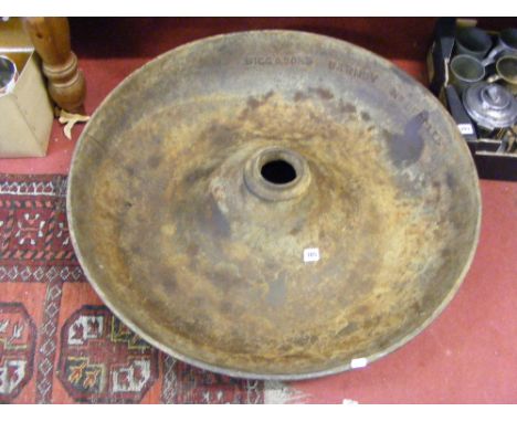 A large antique cast iron animal feeding trough.