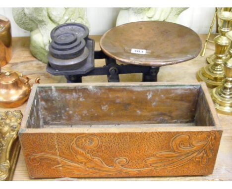 A copper plant trough and a set of scales with copper tray.