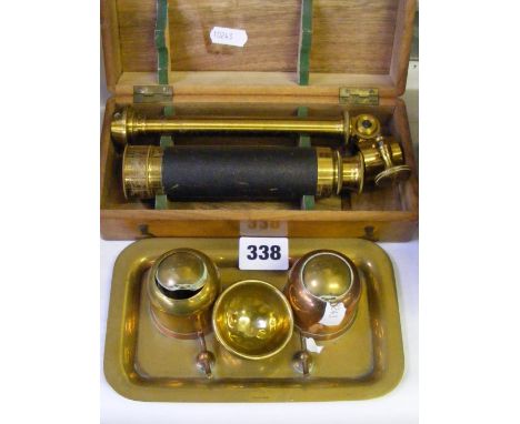 A boxed vintage portable microscope, plus a copper and brass desk set with glass liners.
