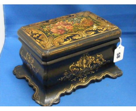 A Victorian lacquered tea caddy with polychrome floral decoration and with a pair of lidded compartments inside.
