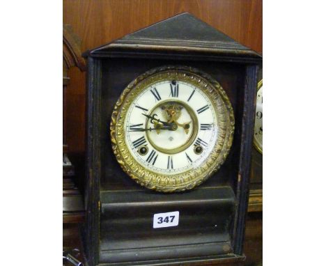 An American striking mantel clock (circa 1880) with visible escapement.    
