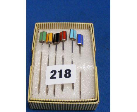 A set of six silver and enamel cocktail sticks marked silver.