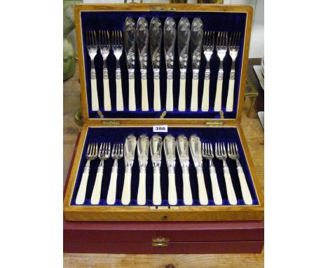 Two boxed sets of six fish knives and forks with bone handles.