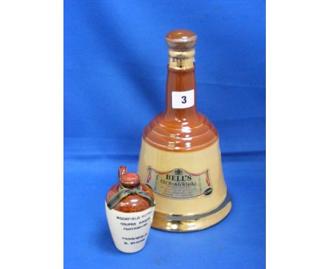 A Wade Bells Scotch Whisky decanter with contents, plus a Border Pottery whisky container.