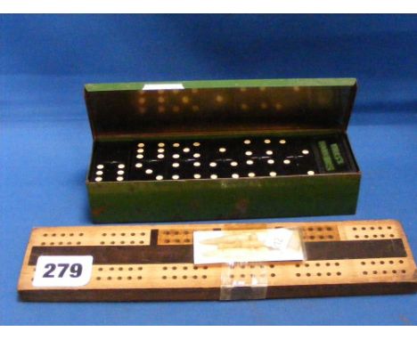 A set of Will's Woodbines dominoes in original tin and a cribbage board with three bone pegs.