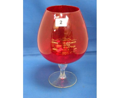 An oversized ruby glass brandy balloon bearing an inscription 'Hammer Film Luncheon to honour Kenneth Hyman London October 11