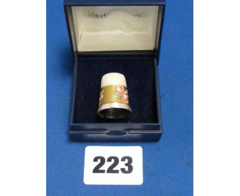 A silver thimble with enamel decoration of roses (boxed).  
