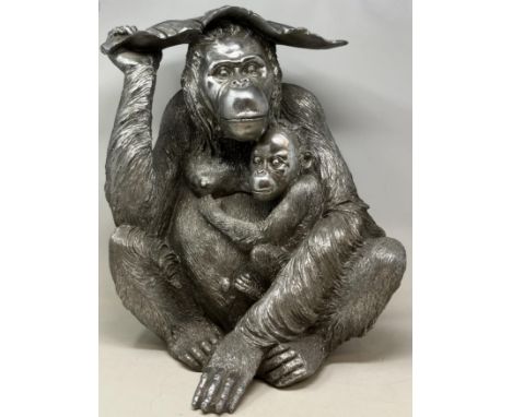 A silvered model of a orangutan, 48 cm high, and assorted blue and white balls (qty) 