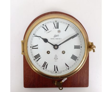 A bulkhead clock, the 12.5 cm diameter enamel dial signed Schatz Royal Mariner, with Roman numerals, in a brass case, 18 cm d