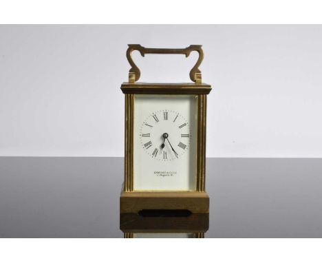 A vintage brass carriage timepiece from Garrard & Co, with handle raised 15cm, case worn, no key
