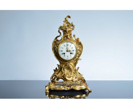 A late 19th or early 20th century brass Louis XVI style mantle clock, 44cm high, white enamel dial, eight day drum movement, 