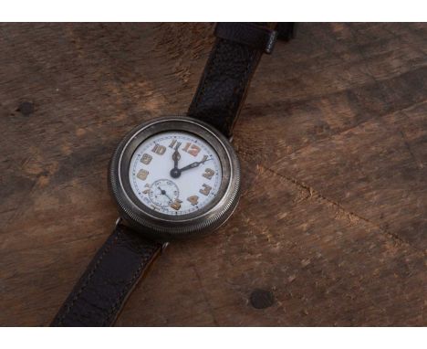 An early 20th century manual wind silver wrist watch,  41mm, with screw of besel and hinged movement, white enamel dial, on b