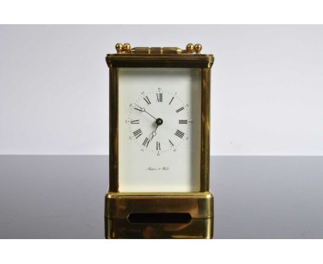 A vintage brass carriage timepiece from Mappin & Webb, with handle raised 18.5cm, key broken, case pitted