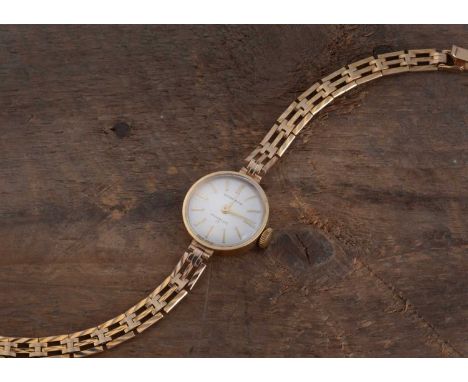 A c1970s Garrard presentation 9ct gold lady's manual wind wristwatch, 19.5mm case on integrated gate link 9ct gold bracelet, 