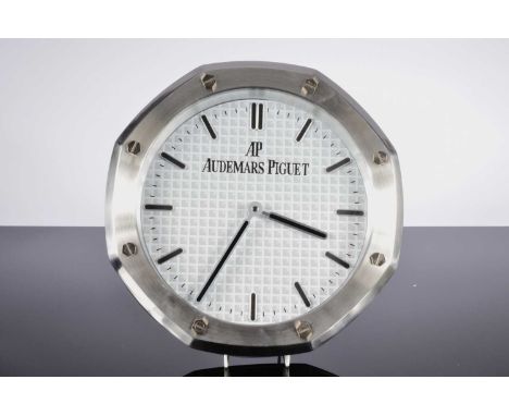 A modern wall clock, 34cm diameter, in the style of a Audemars Piguet in brushed metal watch dealers clock, unused and operat