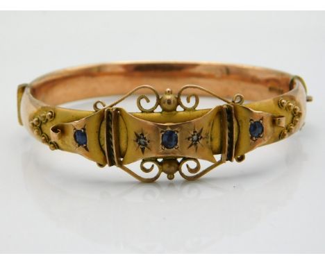 An antique 9ct rose &amp; yellow gold bangle set with sapphire &amp; diamond, internal measurement 59mm diameter at widest, 1