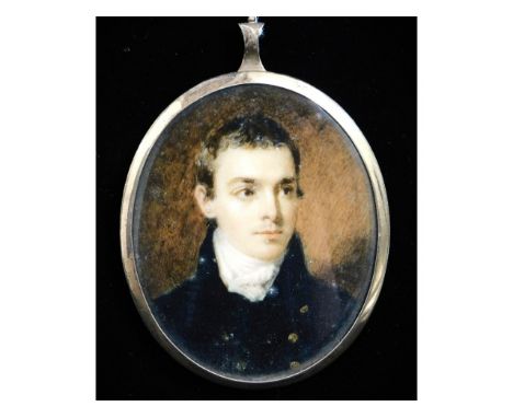 A miniature portrait of a young gentleman in dark blue coat with brass buttons &amp; white cravat, set in gilt metal frame. S