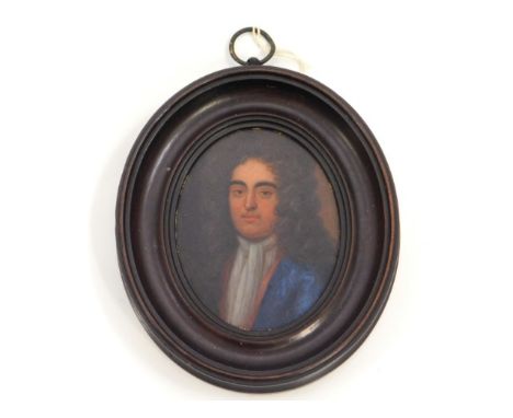 An early 18thC. miniature oil portrait of a gentleman, member of the Churchill family wearing blue coat &amp; white cravat, i