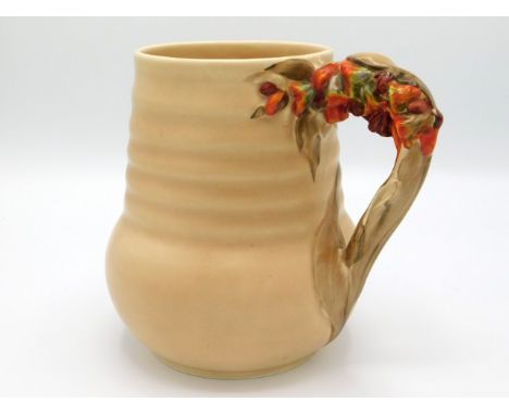 A Clarice Cliff jug with organic floral handle, pattern no. 811, 6.5in tall