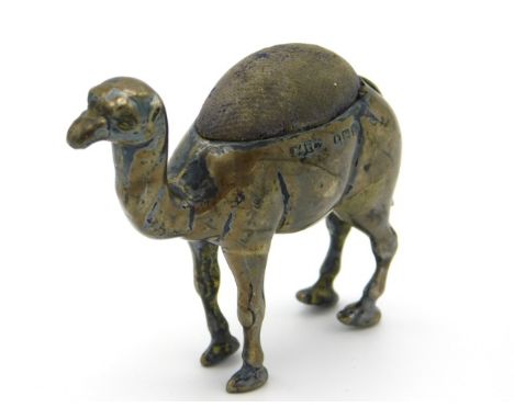 An Edwardian,1907 Birmingham silver camel pin cushion by Adie &amp; Lovekin Ltd. 51mm high, 25.9g 