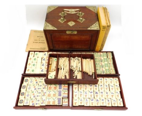 An early/mid 20thC. cased Chinese five drawer bone Mahjong set twinned with various instruction manuals, box 9.5in wide x 6.5