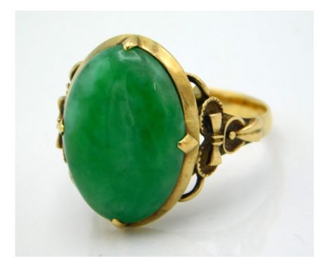 A 9ct closed back ring set with jade stone measuring 17mm x 12mm, size O/P, 5.2g