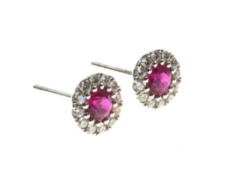 Pair of ruby and diamond cluster ear studs, in 18ct white gold, 1.5g gross approx, lacking keepersThe rubies 3.8mm diameter a