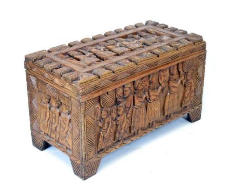 West African carved wooden trunk or bedding chest, decorated to all sides with narrative panels of figures, including chiefs 