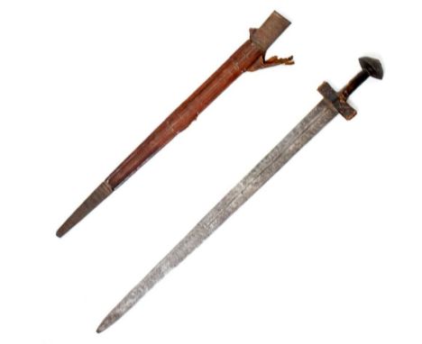 Saharan Tuareg/ Takouba sword the clad tooled leather handle of traditional form, wide oval raised pommel, blade length 67cm 