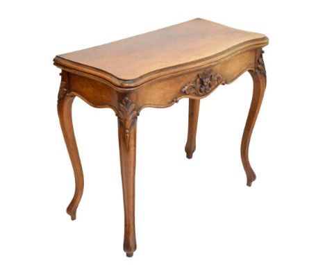 Late 19th Century French walnut serpentine front fold over card table raised on cabriole supports with foliate carving, 85cm 