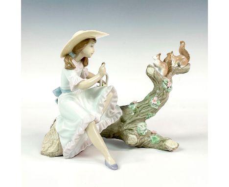 Glossy porcelain; modeled as a girl on a tree trunk with two squirrels. Includes original box. Lladro backstamp. Box measures