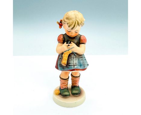 Matte hand-painted figurine; a young girl stitching. Goebel W. Germany backstamp. Issued: 1972 - 1979Dimensions: 2.5"W x 6.75