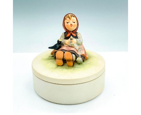 Candy box with a girl singing with a bird and knitting in a field. Goebel backstamp, and III/69 item number imprint. Issued: 