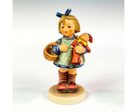 A young girl holds a basket and her toy tightly to her body while standing, looking off to the side. Exclusive special editio