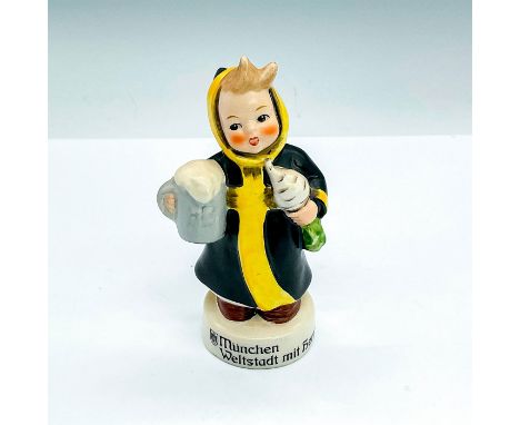 A boy in a black and yellow robe is carrying a mug of beer in one hand and turnip in the other hand. Goebel backstamp and LMu
