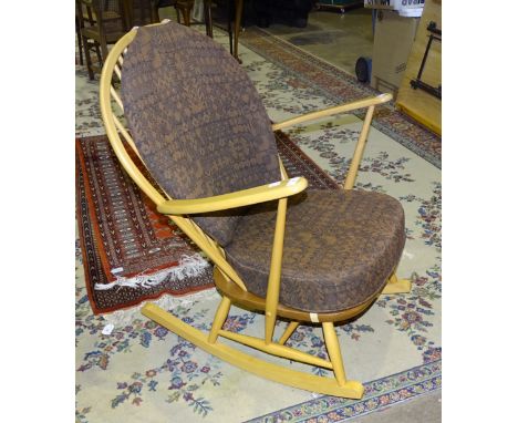 An Ercol elm rocking chair with loose seat and back cushions. 