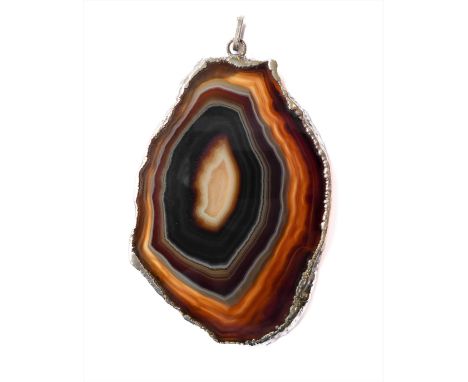 A large irregular-shaped banded agate pendant with silver-mounted border and suspension loop: the stone dark brown to honey/m