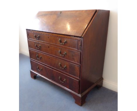 An 18th century walnut writing bureau: the crossbanded slanted fall opening to reveal a fitted interior with central panelled