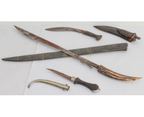 Three bladed weapons: 1. a machete-style knife (with later horn handle) and wooden scabbard (71 cm) 2. a small kukri-style kn