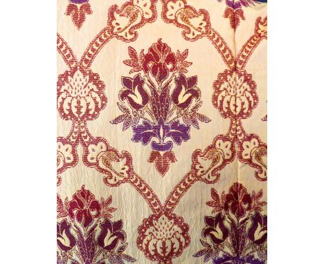 A pair of curtains with a woven terracotta and burgundy floral pattern on a heavy silk-effect background; triple pinch pleat 
