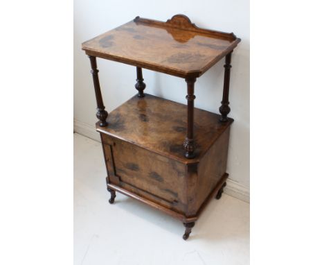 A fine figured walnut (with later painted figured highlights) pier cabinet: the galleried half-veneered top with canted front