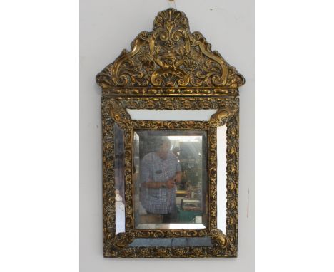 A brass-framed wall-hanging looking glass in&nbsp;late 17th century style (probably 19th or early 20th century): the pediment